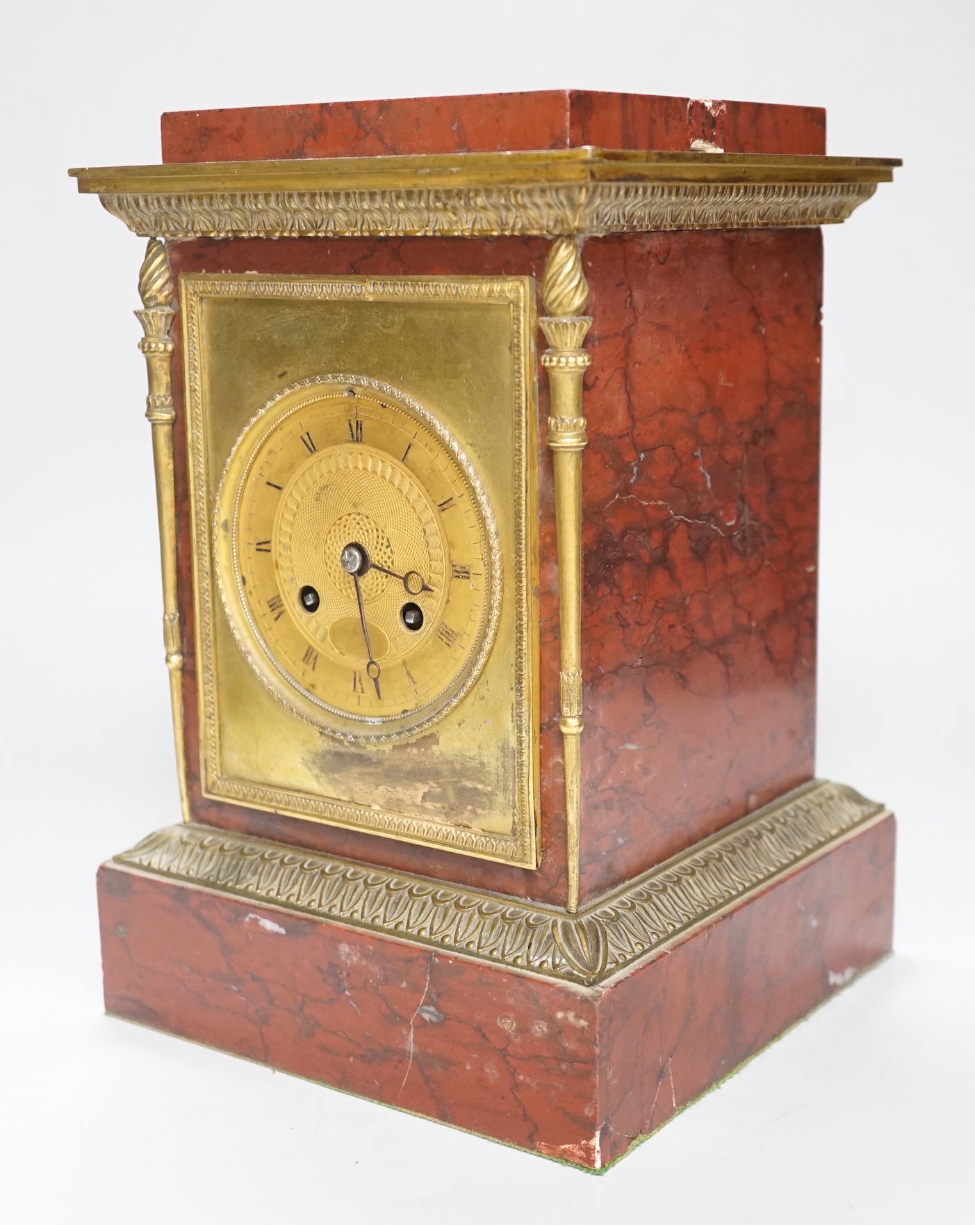 A French gilt metal mounted rouge marble mantel clock, first half 19th century, engine turned dial, 27cm high